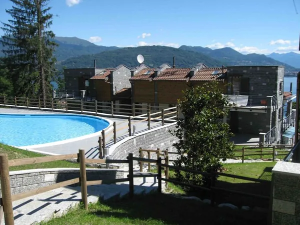 The shared pool below the residence buildings, with mountains across the lake