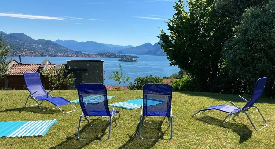 Sun loungers on the lawn at the Armonie del Lago residence, looking over Lake Maggiore